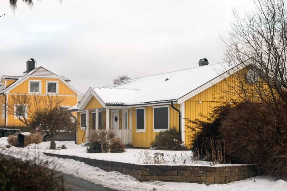 Charming yellow houses in a snowy winter landscape, offering a warm and inviting atmosphere.